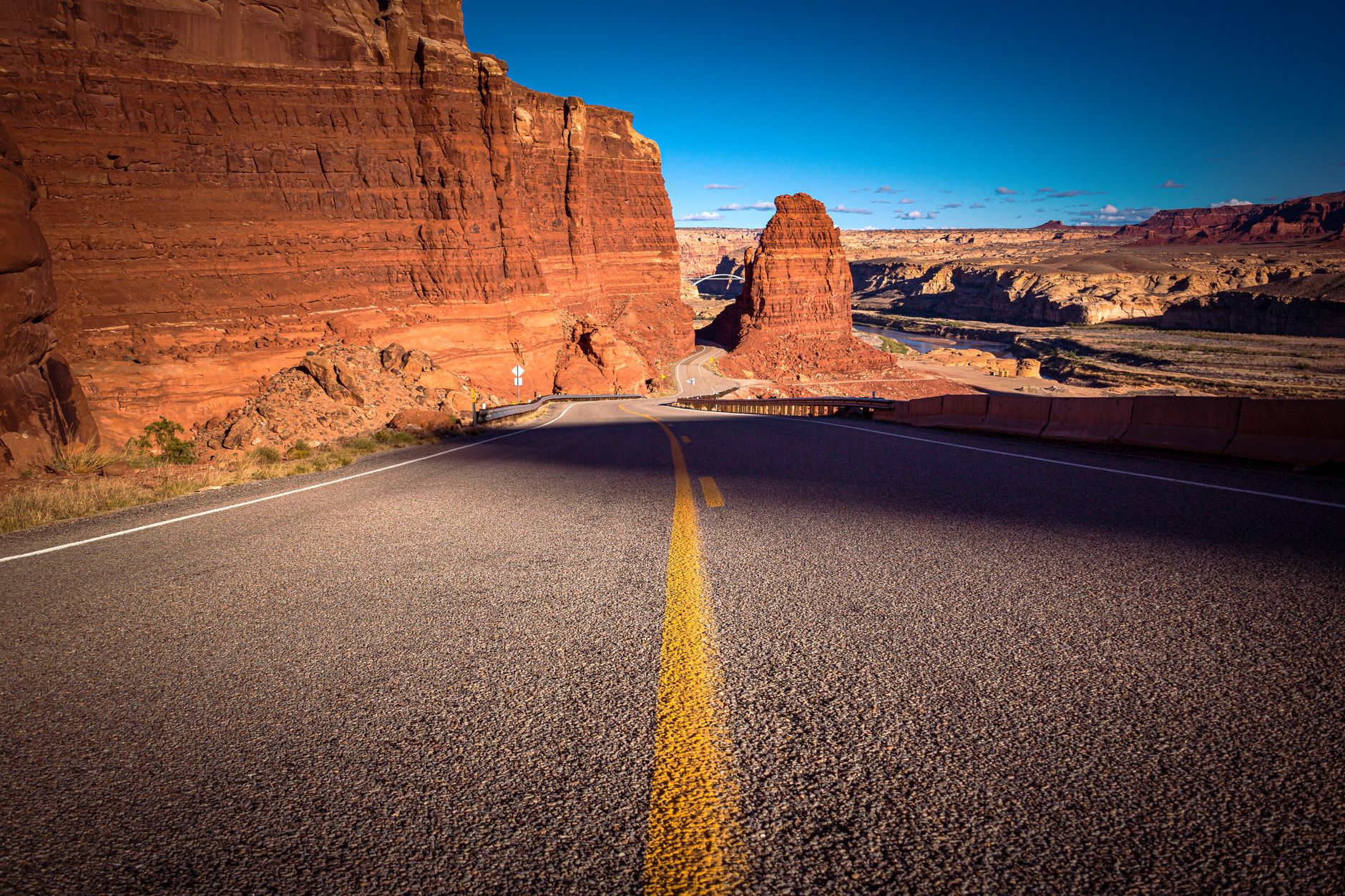 Towering red sandstone cliffs under clear desert sky